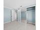 Spacious bedroom boasts tiled floors and sliding mirror door closet at 146 Francis Ne Dr, Port Charlotte, FL 33952