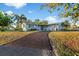 Charming single-story home featuring a long driveway, well-maintained lawn, and beautiful mature landscaping at 146 Francis Ne Dr, Port Charlotte, FL 33952