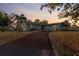 Charming single-story home featuring a long driveway, well-maintained lawn, and beautiful mature landscaping at 146 Francis Ne Dr, Port Charlotte, FL 33952