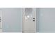 Interior view of a pristine white front door with diamond-patterned glass inset at 146 Francis Ne Dr, Port Charlotte, FL 33952