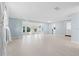 Bright, airy living room with tile floors and an open layout leading to a sunroom and kitchen at 146 Francis Ne Dr, Port Charlotte, FL 33952