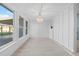 Bright living room boasts a modern chandelier and sleek tile flooring and plenty of natural light at 146 Francis Ne Dr, Port Charlotte, FL 33952