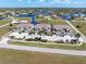Aerial view of condos, parking, and scenic lakes in a deed-restricted community at 17094 Acapulco Rd # 312, Punta Gorda, FL 33955