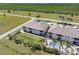 Aerial view of condominiums with a pool, offering a serene and picturesque living environment surrounded by lush landscapes at 17094 Acapulco Rd # 312, Punta Gorda, FL 33955