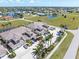 Aerial view of condos, parking, and scenic lakes in a deed-restricted community at 17094 Acapulco Rd # 312, Punta Gorda, FL 33955
