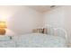 Bright bedroom with a decorative metal bed frame, adjacent closet, and neutral walls at 17094 Acapulco Rd # 312, Punta Gorda, FL 33955