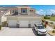 Close up of townhome exterior featuring tile roof, two-car garage, and neutral stucco facade with well-maintained landscaping at 17094 Acapulco Rd # 312, Punta Gorda, FL 33955