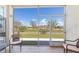 Relaxing screened-in lanai with comfortable seating and a beautiful view of the outdoors at 17094 Acapulco Rd # 312, Punta Gorda, FL 33955