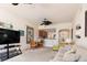 Bright living room with comfortable seating, ceiling fan, and open access to the kitchen at 17094 Acapulco Rd # 312, Punta Gorda, FL 33955
