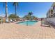 Community pool with brick pavers, plenty of lounge chairs, and nearby community buildings at 17094 Acapulco Rd # 312, Punta Gorda, FL 33955