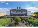 Community sign for Burnt Store Lakes surrounded by lush landscaping at 17094 Acapulco Rd # 312, Punta Gorda, FL 33955