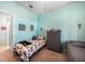 Bright bedroom featuring tile floors, a twin bed, and dresser at 17408 Malarky Ln, Punta Gorda, FL 33955