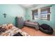 Bedroom with two beds, dresser, and natural light from the window at 17408 Malarky Ln, Punta Gorda, FL 33955