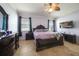 A bedroom with tile flooring has a ceiling fan, good window light, and nice furniture at 17408 Malarky Ln, Punta Gorda, FL 33955