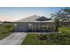 Beautiful home exterior featuring a well-maintained lawn and attached garage at 17408 Malarky Ln, Punta Gorda, FL 33955