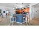 The kitchen has wood cabinets, stainless steel appliances, and a breakfast bar with seating at 17408 Malarky Ln, Punta Gorda, FL 33955