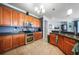 A kitchen features ample wood cabinets, modern stainless appliances, and tile flooring at 17408 Malarky Ln, Punta Gorda, FL 33955