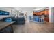 Open-concept living space with a modern kitchen, cozy living area, and tile flooring throughout at 17408 Malarky Ln, Punta Gorda, FL 33955