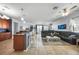 Open-concept living area featuring a modern kitchen, comfortable seating, and tile flooring at 17408 Malarky Ln, Punta Gorda, FL 33955