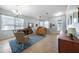 The living room offers tile flooring, neutral walls, a piano, and comfortable furniture at 17408 Malarky Ln, Punta Gorda, FL 33955