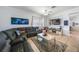 Inviting living room with a large sectional, stylish decor, and a mounted TV for entertainment at 17408 Malarky Ln, Punta Gorda, FL 33955