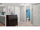 Hallway view leading to a bathroom with modern fixtures and a blue patterned shower curtain at 19505 Quesada Ave # F103, Port Charlotte, FL 33948