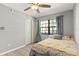 Comfortable bedroom with ceiling fan, closet, and natural light at 19505 Quesada Ave # F103, Port Charlotte, FL 33948