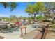Community bocce ball court surrounded by mature trees and benches for residents at 19505 Quesada Ave # F103, Port Charlotte, FL 33948