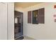 Entryway with security door with window next to brown window shutter with privacy at 19505 Quesada Ave # F103, Port Charlotte, FL 33948