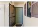Welcoming front door with storm door and side window with brown shutters at 19505 Quesada Ave # F103, Port Charlotte, FL 33948