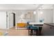 View of an open space kitchen, displaying pendant lights, a dining island, and light hardwood floors at 19505 Quesada Ave # F103, Port Charlotte, FL 33948