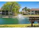 Beautiful community pond with a fountain feature and manicured lawns and complex in background at 19505 Quesada Ave # F103, Port Charlotte, FL 33948