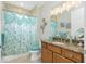 This bathroom has a shower/tub combo with floral shower curtain and granite vanity at 21 Manizaks Ave, Punta Gorda, FL 33983