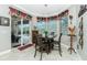 Bright breakfast nook features a sliding door to the pool area and views of the backyard at 21 Manizaks Ave, Punta Gorda, FL 33983