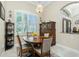 Cozy dining area featuring a chandelier, shutters, and built in glass door cabinets at 21 Manizaks Ave, Punta Gorda, FL 33983