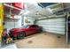 Two car garage with storage racks and a sporty red car at 21 Manizaks Ave, Punta Gorda, FL 33983