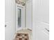 Hallway with a view of the lanai through a glass door, and white walls at 21 Manizaks Ave, Punta Gorda, FL 33983