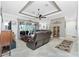 Inviting living room with a view of the lanai, tile flooring, and neutral decor at 21 Manizaks Ave, Punta Gorda, FL 33983