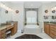 Bright bathroom features double vanities, a garden tub and decorative light fixtures at 21 Manizaks Ave, Punta Gorda, FL 33983