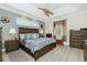 This main bedroom has a tray ceiling, ceiling fan and en suite bathroom with double vanities at 21 Manizaks Ave, Punta Gorda, FL 33983
