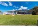 Spacious backyard features a pool in large screened enclosure and direct canal access at 21269 Edgewater Dr, Port Charlotte, FL 33952
