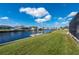 Scenic backyard featuring a private dock and boat lift on a serene canal with neighboring houses at 21269 Edgewater Dr, Port Charlotte, FL 33952