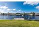 A wooden dock overlooking the channel behind the property at 21269 Edgewater Dr, Port Charlotte, FL 33952