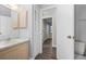 A bright bathroom features a single sink, wood-look floors, and a built-in cabinet at 21269 Edgewater Dr, Port Charlotte, FL 33952