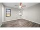 Bedroom showcasing natural light from the windows, wood-look flooring, and a ceiling fan at 21269 Edgewater Dr, Port Charlotte, FL 33952