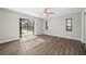 A spacious room with new flooring, ceiling fan, and views of the screened-in pool at 21269 Edgewater Dr, Port Charlotte, FL 33952
