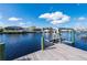 Close-up of a private boat lift on a serene canal, with waterfront homes visible in the background at 21269 Edgewater Dr, Port Charlotte, FL 33952
