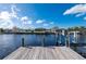 View from private wooden dock with boat lift, looking towards waterfront homes across the canal at 21269 Edgewater Dr, Port Charlotte, FL 33952