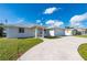 Charming home with a two-car garage, well-manicured lawn, and a spacious driveway at 21269 Edgewater Dr, Port Charlotte, FL 33952