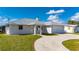 Charming single-story home with manicured lawn, two-car garage, and curved driveway at 21269 Edgewater Dr, Port Charlotte, FL 33952